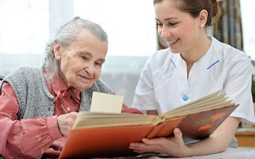 Carer and customer looking at a book